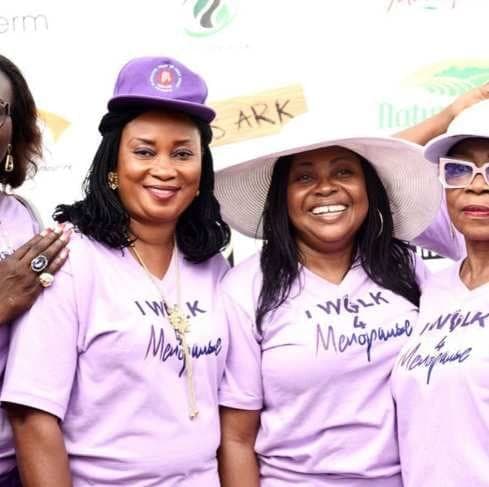 Women in lilac iWalk4Menopause shirts and sun hats